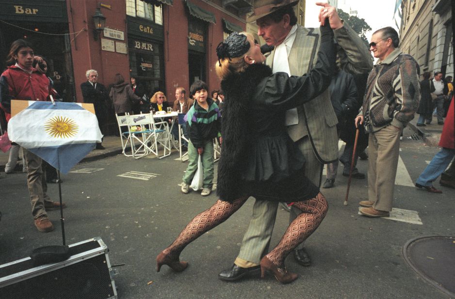 An old couple dressed in immaculate 1920s garments do the tango in the middle of San Telmo street while a young boy looks on. Migdalia Romero, author of the "Tango Lover's Guide to Buenos Aires" says that, to this day, tango is loved by all generations across the city. 