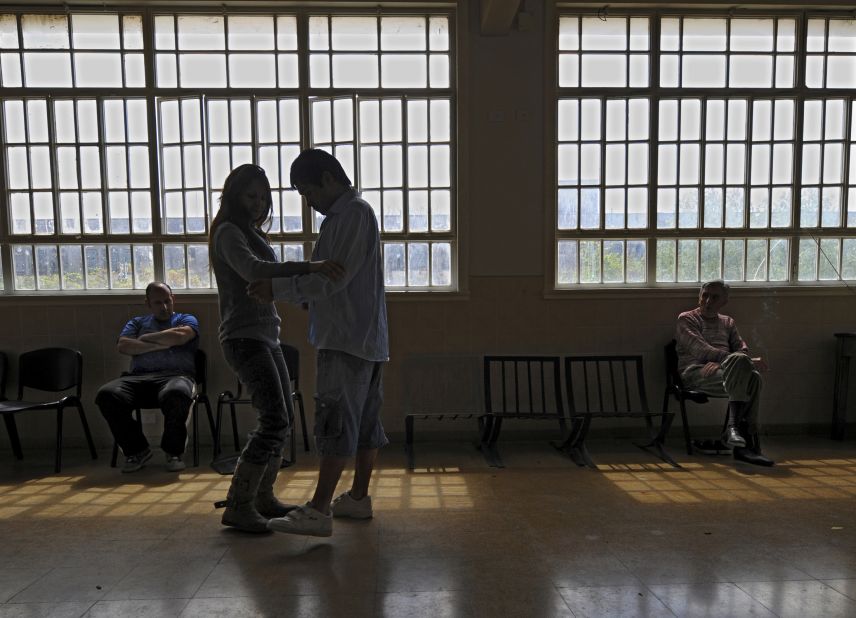Tango is so loved in Buenos Aires that it is even used as a form of therapy. Here a nurse and a patient dance during a "tango-therapy" session at Borda psychiatric hospital.