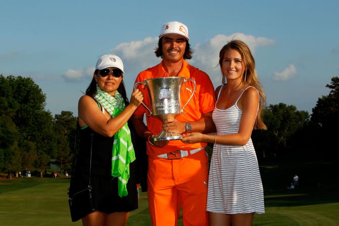 Fowler holds the Wells Fargo Championship trophy alongside his mother Lynne (letf) and girlfriend Alexandra Brown.