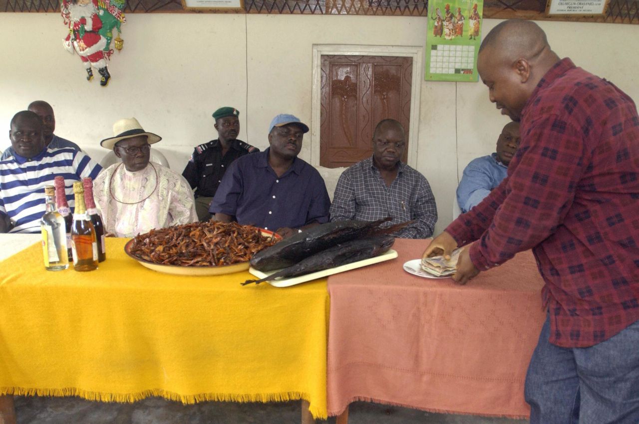 Concealing criminal convictions in the UK, James Ibori rose to become governor of Delta State. Here, he receives gifts of fish, liquor and money from Ijaw villagers as he tours the western Niger Delta in 2003.