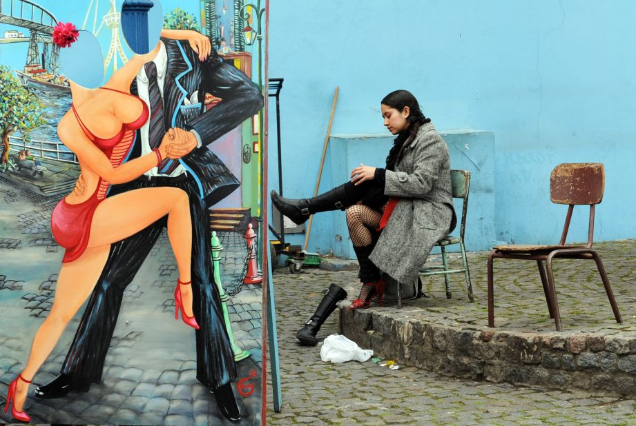 A tango dancer changes her boots for high-heeled shoes before a performance at Caminito Street in the La Boca neighborhood -- widely known for the football club Boca Juniors -- and for its vivid tango-themed murals. 