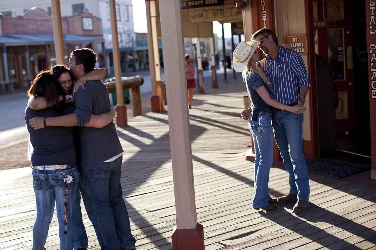 At left, Nancy Sosa hugs her two children while Kevin Rudd and his fiancee, Sherry Kammeyer, embrace in downtown Tombstone, Arizona. All three work for the city of Tombstone and play key roles in the water drama.