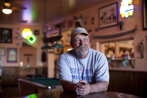 Schmidt is pictured inside his bar, Johnny Ringo's, in Tombstone. He won the recall election by 51 votes but says he will continue the city's lawsuit under the conservative Goldwater Institute.