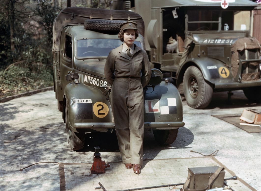 Auxiliary Territorial Service: Princess Elizabeth, a 2nd Subaltern in the ATS, wearing overalls and standing in front of an L-plated truck. In the background is a medical lorry. Courtesy Imperial War Museum 