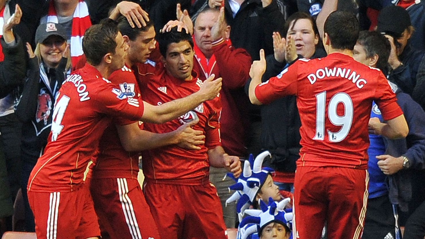 Liverpool's players celebrate after Luis Suarez (C) created their opening goal against Chelsea at Anfield
