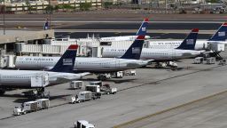 PHOENIX, AZ - APRIL 19: US Airways airplanes sit at terminal four gates at Sky Harbor International Airport on April 19, 2012 in Phoenix, Arizona. As American Airlines continues through bankruptcy US Airways is working on a possible deal to takeover the troubled airline. (Photo by Joshua Lott/Getty Images) 