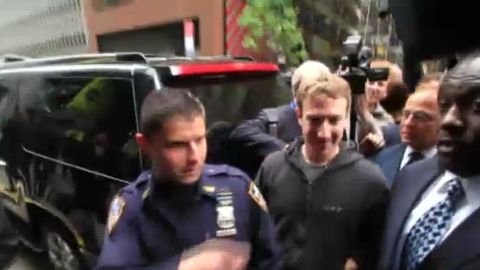 Facebook CEO Mark Zuckerberg arrives to meet with investors in New York on Monday while wearing his iconic hoodie.
