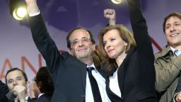 France's Socialist Party (PS) newly elected president Francois Hollande celebrates with his companion Valerie Trierweiler at the Place de la Bastille in Paris on May 7, 2012.