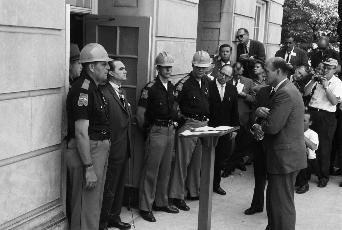 Federal Deputy Attorney General Nicholas Katzenbach, standing on the right, confronts Alabama Gov. George Wallace at the University of Alabama in Tuscaloosa on June 11, 1963. Wallace is standing in the doorway to prevent two African-American students from entering despite a presidential order. Wallace, who was pro-segregation, later stood aside.