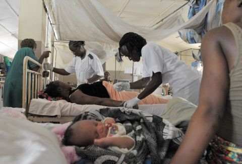 Nurses give aid to a pregnant woman before delivering a baby at the maternity ward of the central hospital in Freetown, Sierra Leone. The country has one of the highest maternal death rates in the world. 
