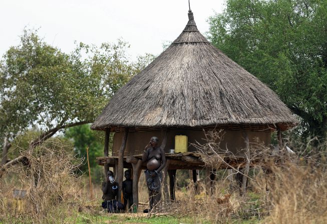 A south Sudanese pregnant mother with her children waits at their homestead in Terekeka, 82 km north of Juba, an area where the population is exposed to malaria. According to Mutoko, in most African rural areas, expectant mothers are mostly taken care of by traditional birth attendants at their households, rather than at hospitals. 