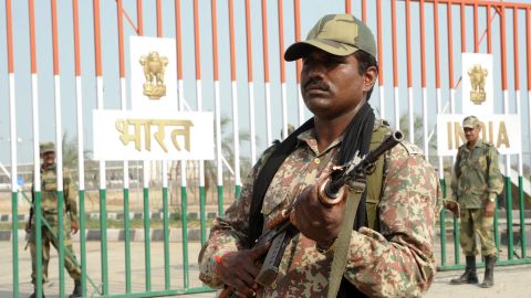 An Indian Border Security Force soldier stands guard beside the gates at the India-Pakistan Wagah Border .