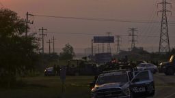 Mexican police block the road between the cities of Monterrey and Reynosa on Sunday. Dozens of mutilated bodies were found nearby.