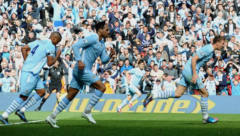 92 minutes: With time added on City grab a lifeline through substitute Edin Dzeko (right). But City need to win. United have beaten Sunderland 1-0!