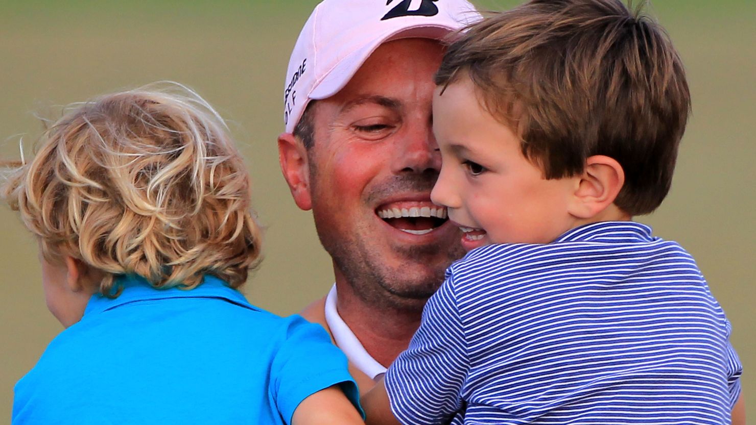 U.S. golfer Matt Kuchar celebrates with his sons Cameron (right) and Carson after winning the Players Championship in Florida.