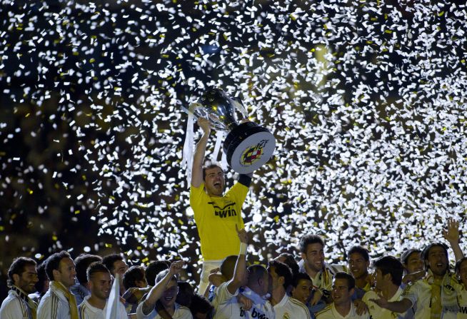 Real Madrid captain Iker Casillas lifts the Spanish Primera Division trophy after Jose Mourinho's team defeated Mallorca 4-1 on Sunday. The 32-time Spanish champions finished the season with 100 points, a record amount.