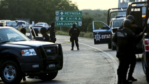 Mexican federal police block the road between Monterrey and Reynosa, where dozens of mutilated bodies were found Sunday.