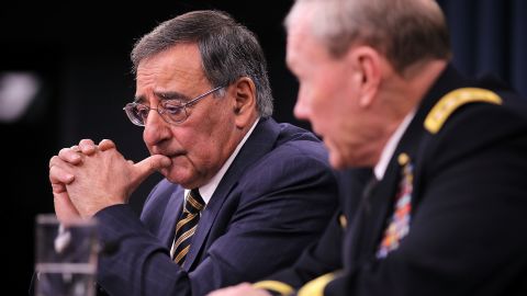 Secretary of Defense Leon Panetta, left, and Gen. Martin Dempsey, chairman of the Joint Chiefs of Staff, attend a news briefing at which Panetta asked Congress not to add any program spending to the federal budget that the Pentagon doesn't need.