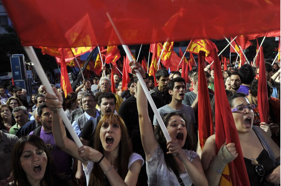 Supporters of the Greek Communist Party waves party flags and chant slogans, during a rally calling for Greece's exit from the Eurozone, on May 14, 2012.