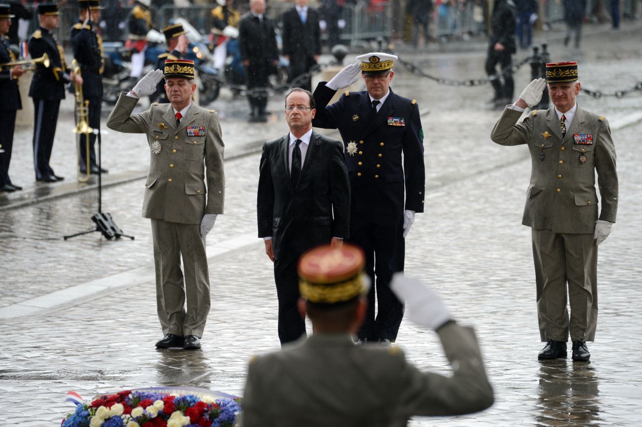 French President Francois Hollande pays his respects after laying a wreath at the Tomb of the Unknown Soldier at the Arc de Triomphe in Paris on Tuesday, May 15.