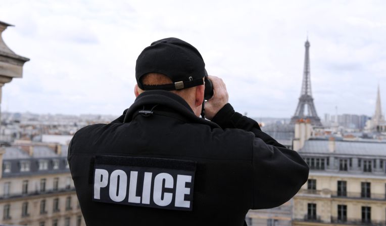 A special police unit sniper stands guard on a roof during Tuesday's investiture ceremony.