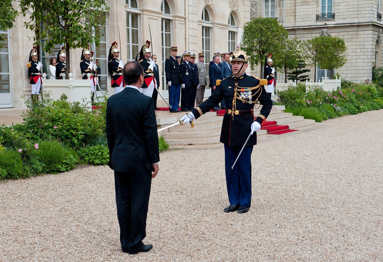 Hollande reviews the troops after officially becoming France's new president at the Élysée Palace.