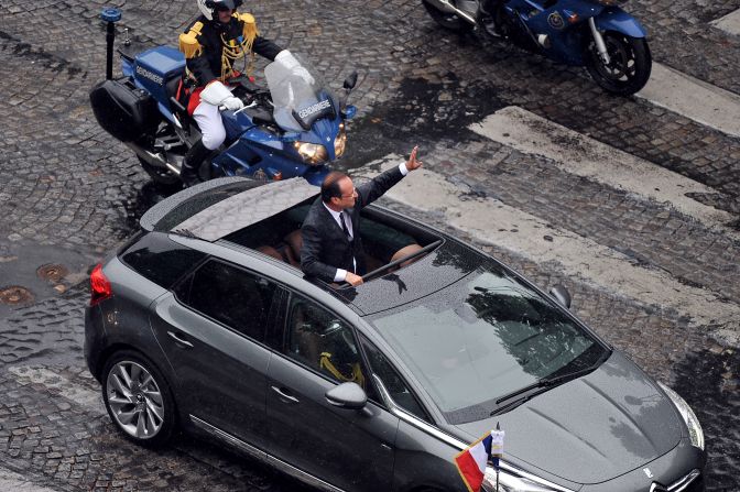 Hollande greets supporters along the Avenue des Champs-Élysées.