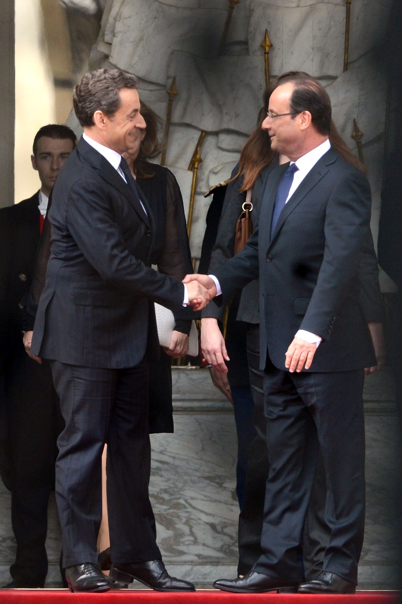 Outgoing President Nicolas Sarkozy, left, welcomes his successor at the Élysée Palace.