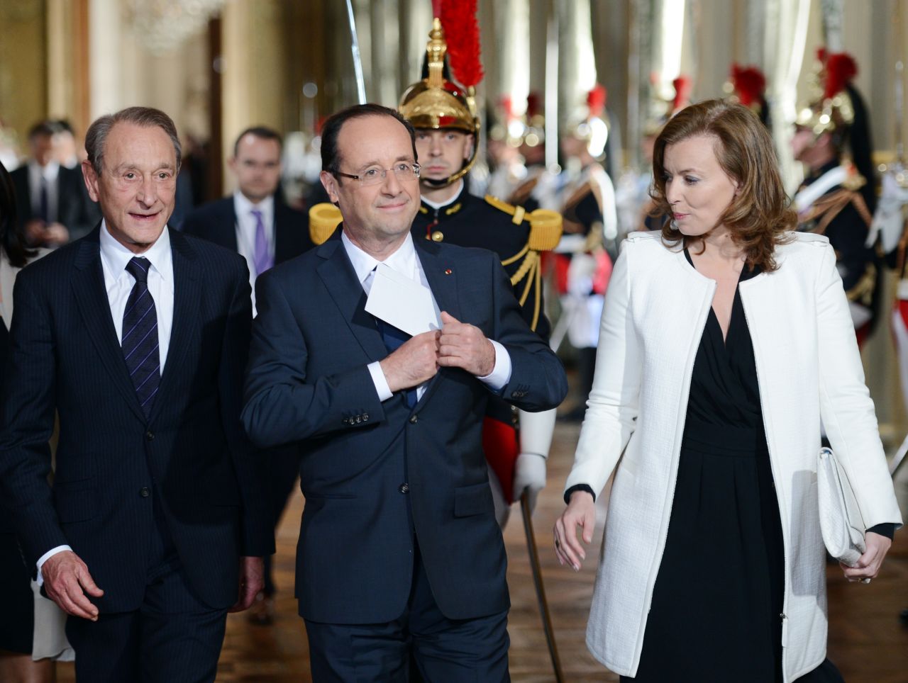 Hollande is flanked by his companion, Valerie Trierweiler, and Paris Mayor Bertrand Delanoe as he arrives to deliver a speech at Paris' town hall.