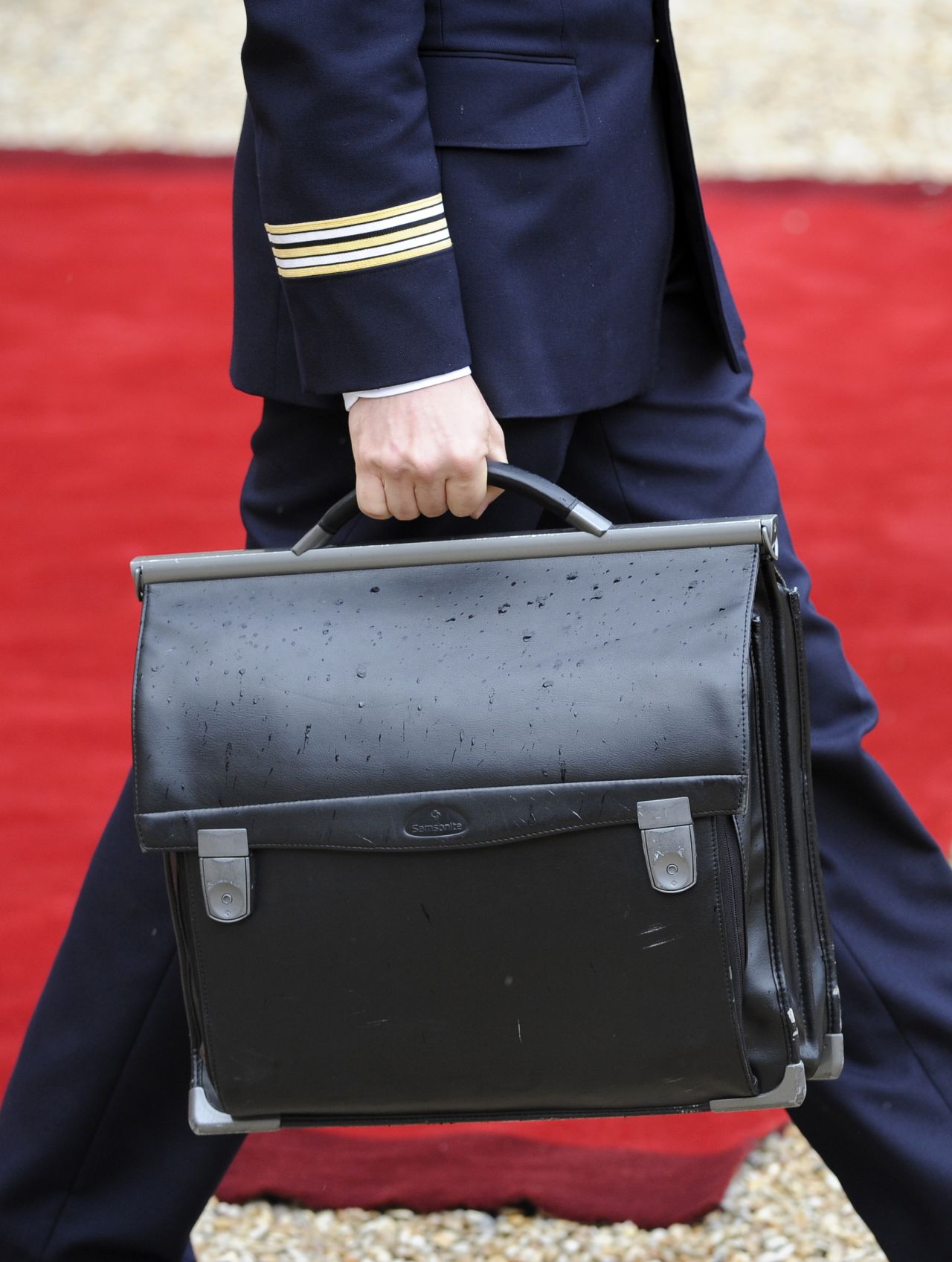 The French president's nuclear satchel is carried through the Élysée Palace.
