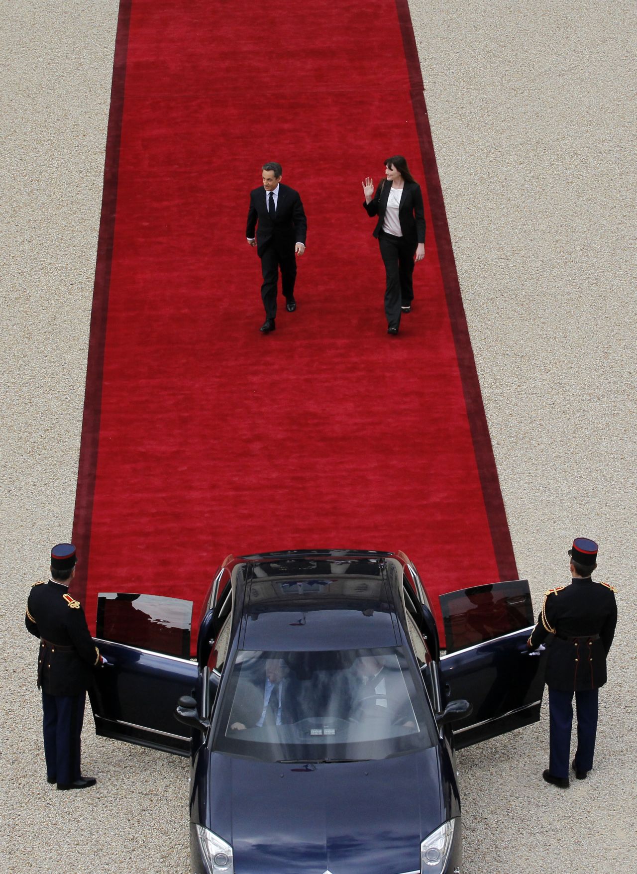 Sarkozy and his wife, Carla Bruni-Sarkozy, leave the Élysée Palace.