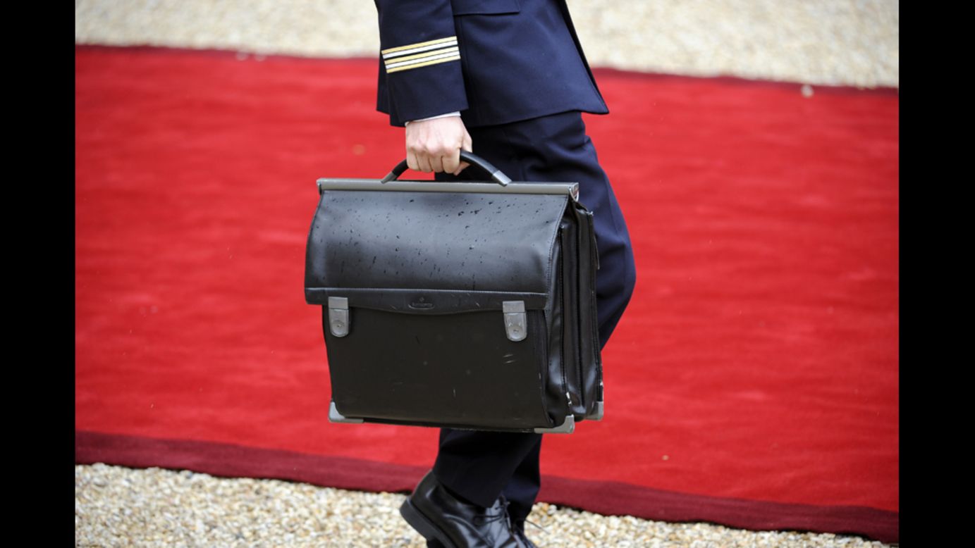 An officer walks with the nuclear satchel of France's President Francois Hollande during Tuesday's formal investiture ceremony at the Elysee Palace in Paris.