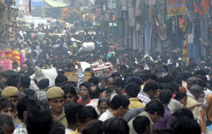 Prospective Indian customers shop for gifts and decorative items along the old city's merchant district of Chandni Chowk. This is one of India's main shopping thoroughfares with stalls selling brightly colored candies, even brighter saris, homecare products, discount electrical goodies, and much else besides.