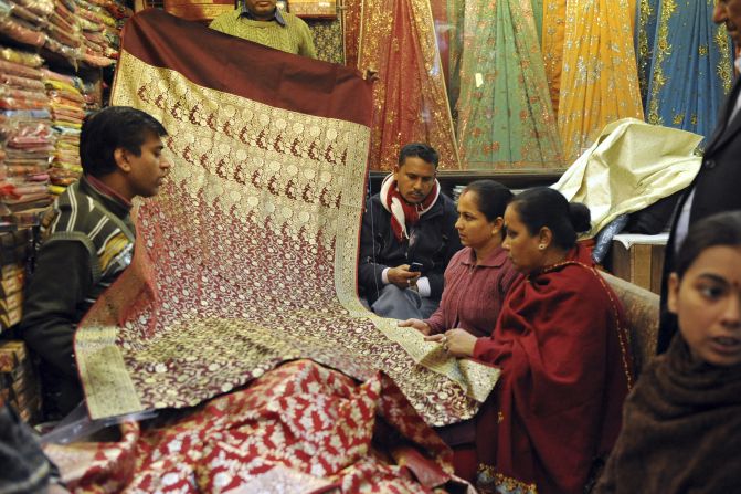 Shoppers browse through saris for sale at a shop in Connaught Place, one of New Delhi's most prosperous centers and a consumer paradise. The "Banarasi" silk saris pictured here are famed for their embroidery and are still sought after by northern Indian brides for their wedding day.