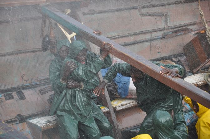 Characters in "La Pirogue" weather treacherous conditions in their wooden boat.