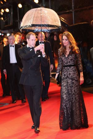 Prince William kept his wife dry at the London premiere of "War Horse" on January 8, 2012. She wore a black lace <a href="index.php?page=&url=http%3A%2F%2Fnymag.com%2Fdaily%2Ffashion%2F2012%2F01%2Fkate-middleton-war-horse-premiere-temperley.html" target="_blank" target="_blank">Alice by Temperley</a> gown and carried a black clutch.