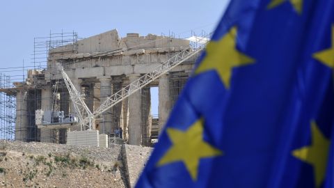 An EU flag is flies in front of the ancient Acropolis in Athens on May 9, 2012. 