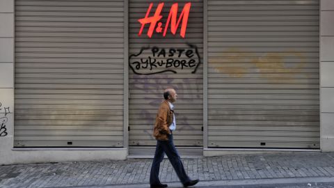 A man passes by a closed shop in central Athens shopping area during a general strike last fall.