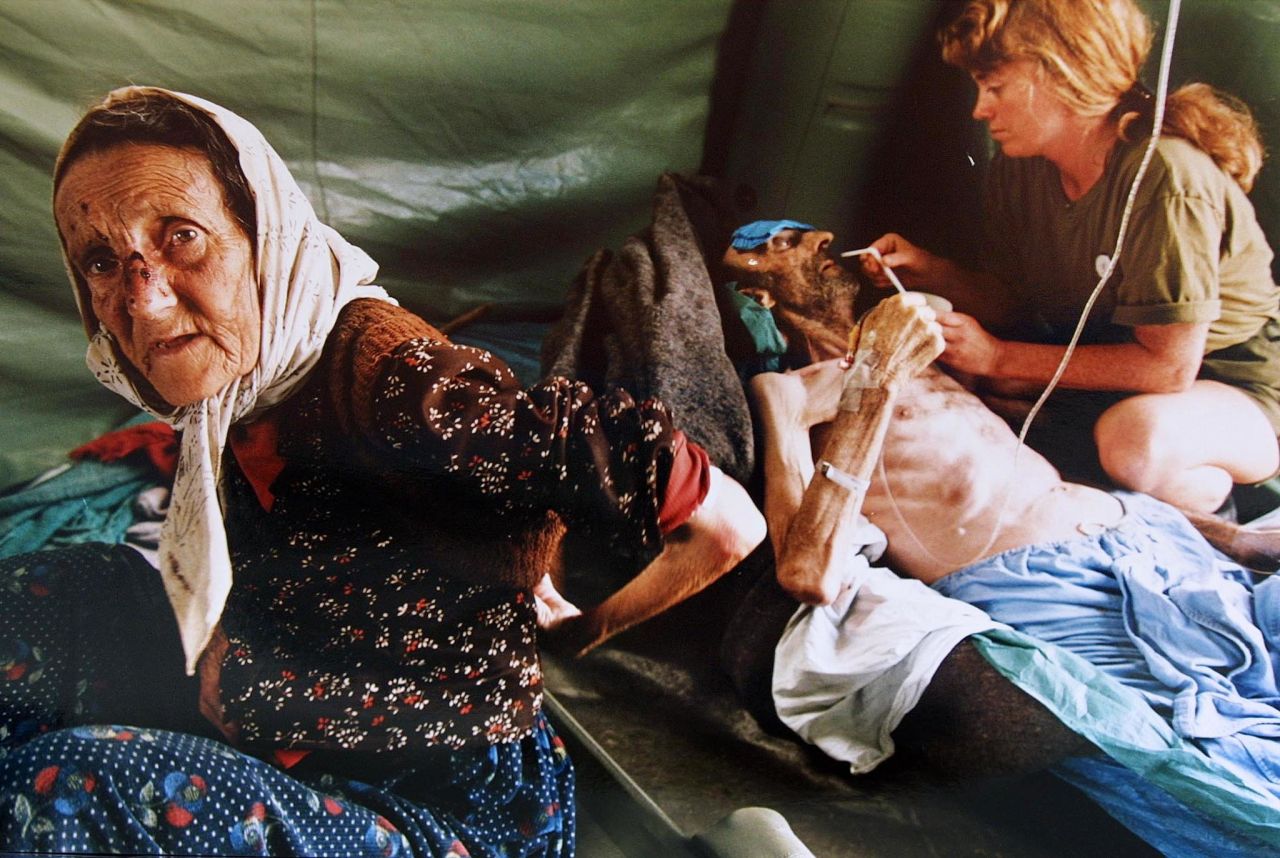 A Muslim woman and her husband are treated in July 1995 for injuries inflicted on them by Serb forces as they fled Srebrenica. The man died shortly after the picture was taken. 