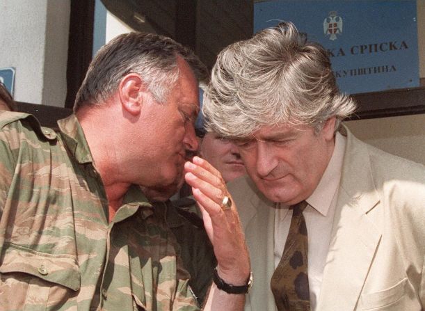 Bosnian Serb leader Radovan Karadzic, right, confers with his military chief during a meeting with the press in Pale on August 5, 1993.