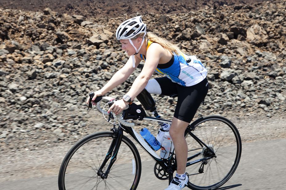 Castelli, a below-the-knee amputee, rides her bike through the lava fields.