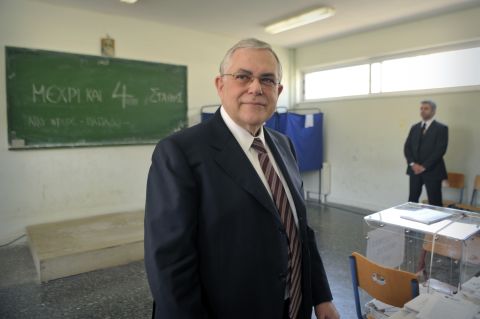Former Greek Prime Minister Lucas Papademos prepares to cast his vote at the May 6 elections. Papademos was tasked with implementing Greece's second bailout package, which it was forced to take after the first aid package, given two years ago, failed to push the country out of recession.