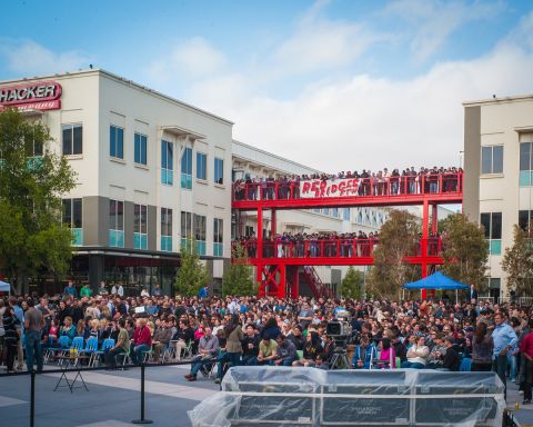 A crowd gathers in an outdoor plaza, dubbed Hackers Square, to hear Facebook's CEO kick off the Hackathon. 