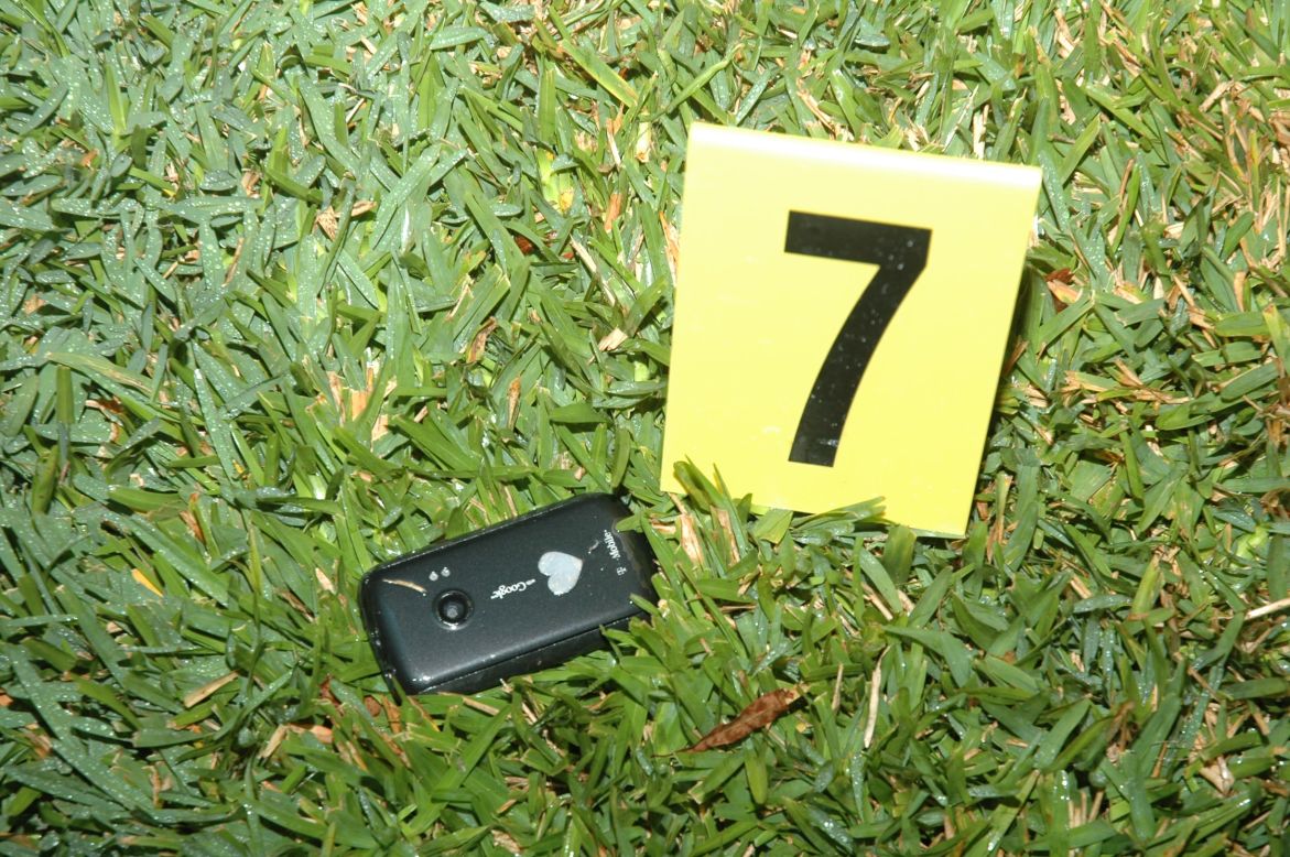 Crime scene photos released by the Sanford Police Department show Trayvon Martin's cell phone at the scene of the shooting.