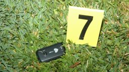 Crime scene photos released by the Sanford Police Department show Trayvon Martin's cell phone at the scene of the shooting.
