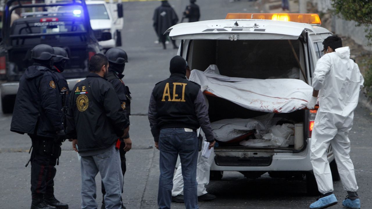 Medical personnel remove one of three bodies killed in drug violence in February in Monterrey, Mexico. 