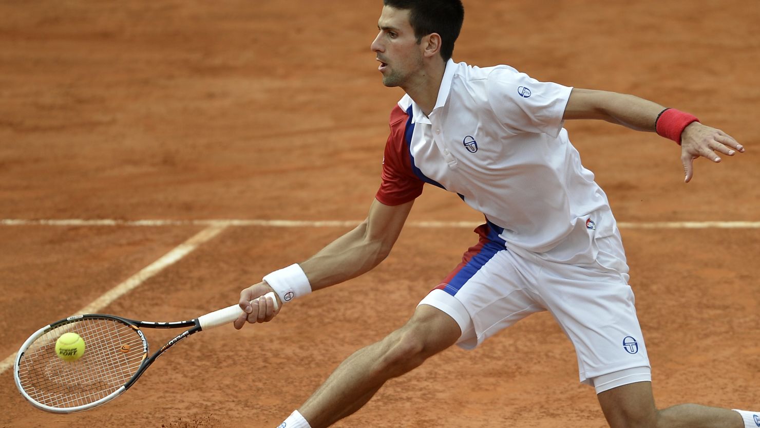 Novak Djokovic plays a return during his straight sets win over Jo-Wilfried Tsonga in the Rome quarterfinals.
