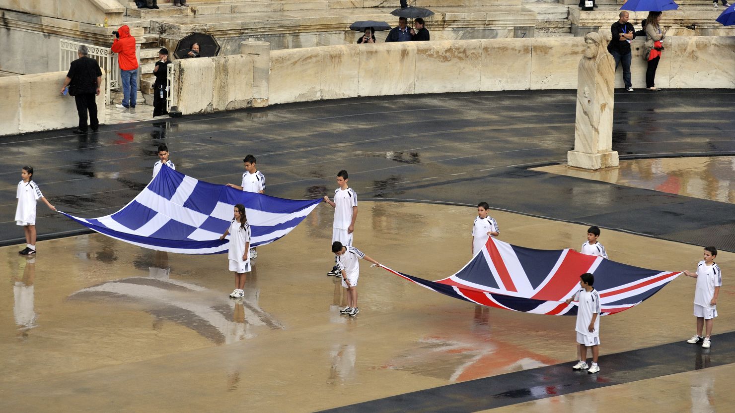 Children hold British and Greek flags during the handover ceremony for the 2012 London Olympics in Athens on Thursday.