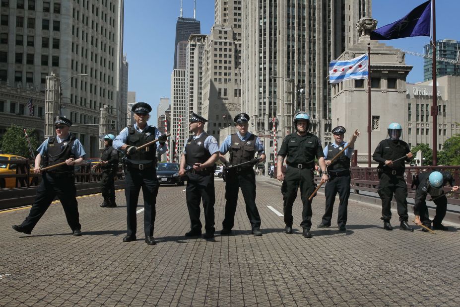Officers form a line to prevent protesters from crossing the Michigan Avenue Bridge during protests on Friday.