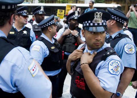 Chicago police watch over protesters during demonstrations organized by National Nurses United in Daley Plaza in Chicago.